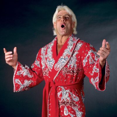 Ric Flair is posing on his red robe.